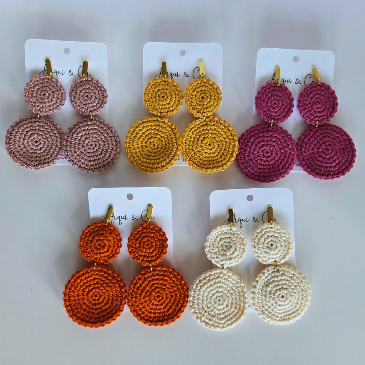 Set of five pairs of round bohemain crochet earrings on white cards with visible brand name.
