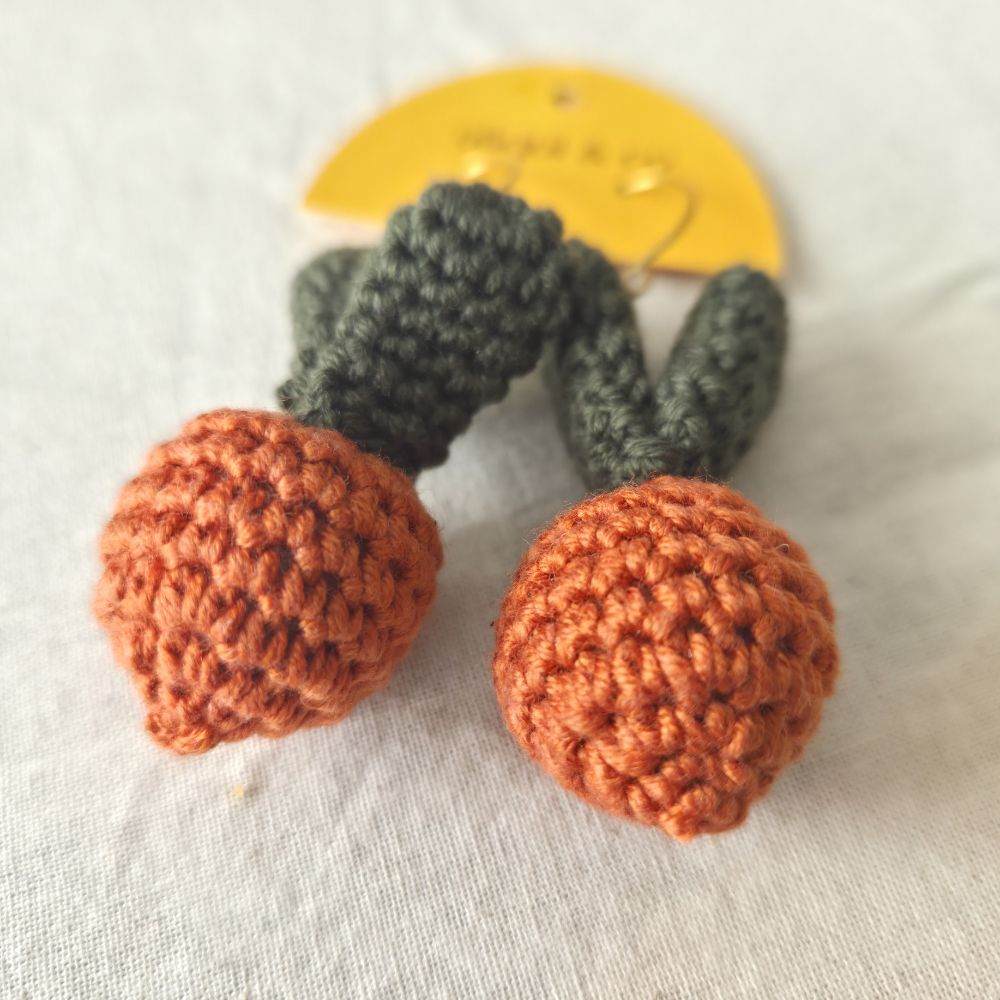 Pair of crocheted Easter earrings on a white background
