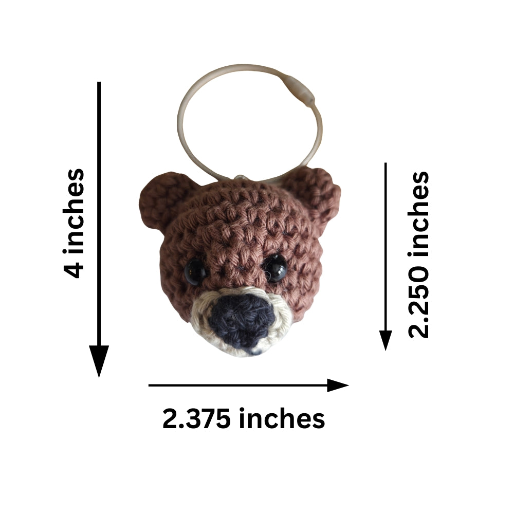 A crocheted bear head keychain with a metal key ring, shown on a white background with black dimension arrows and text indicating 4 inches in height, 2.250 inches in width, and 2.