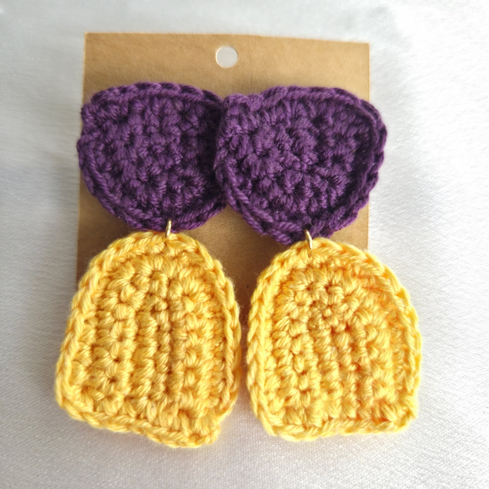 Crocheted colorblock earrings with purple and yellow on a cardboard backing.