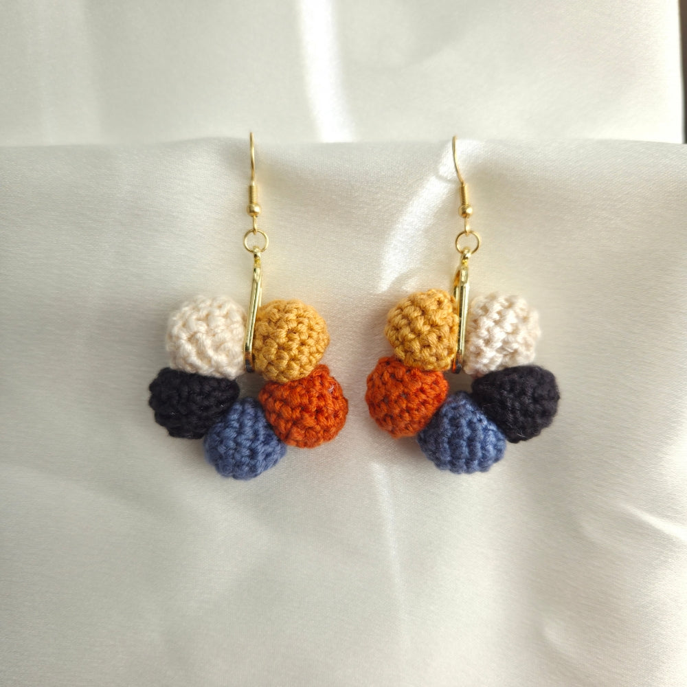 Wood for winter palette crochet earrings on a white background
