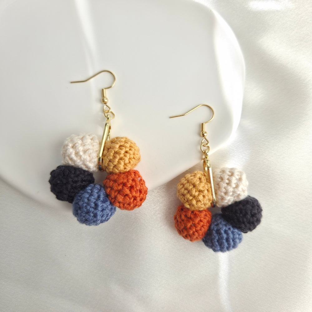 Colorful crocheted earrings on a white background