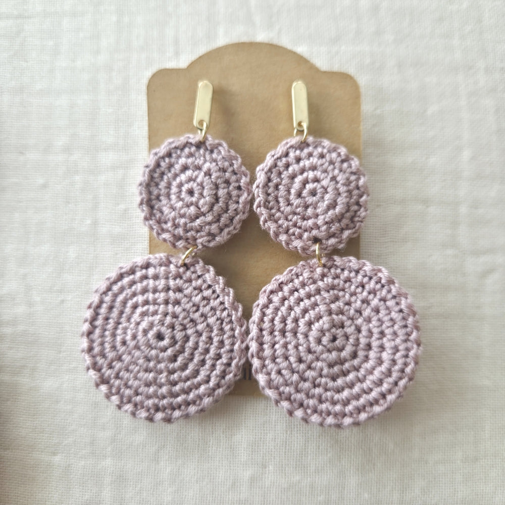 Set of Dusty mauve crochet earrings on a display card against a light background
