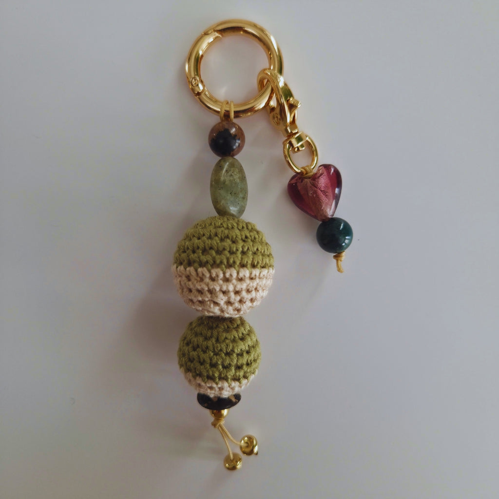 Keychain with crocheted beads and colorful heart charm on a white background