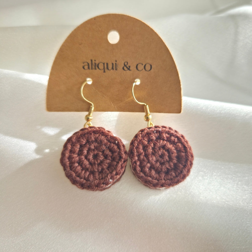 Brown crochet oreo cookie earrings on a 'aliqui & co' branded card against a white background