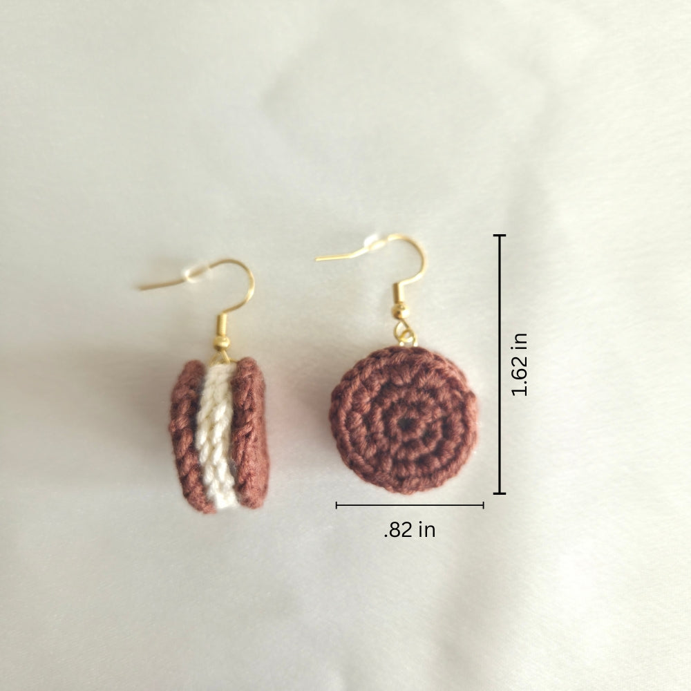 Crocheted cookie earrings with gold hooks and measurements on a light background