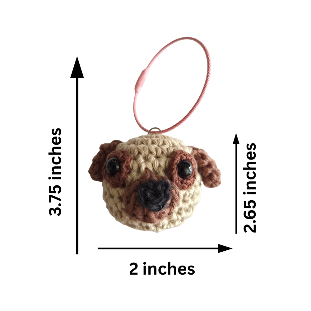 Crocheted pug face keychain with a pink loop, shown with dimension arrows and labels indicating 3.75 inches tall, 2 inches wide, and 2.