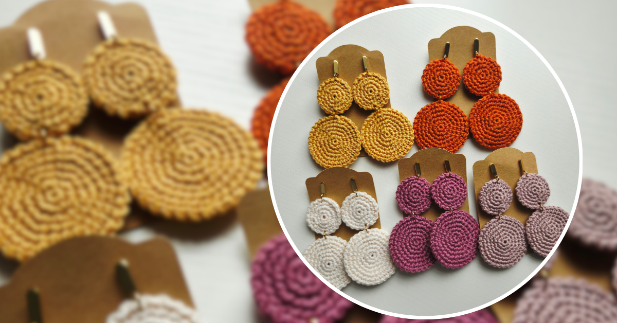 Handmade round woven earrings displayed on brown paper earring cards shown in a close-up circular inset with a softly blurred background of additional earrings in different colors.