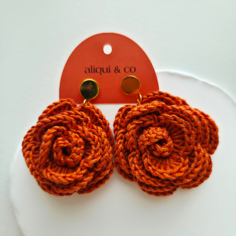 Ginger rose earring in an aliqui & co card on a white background
