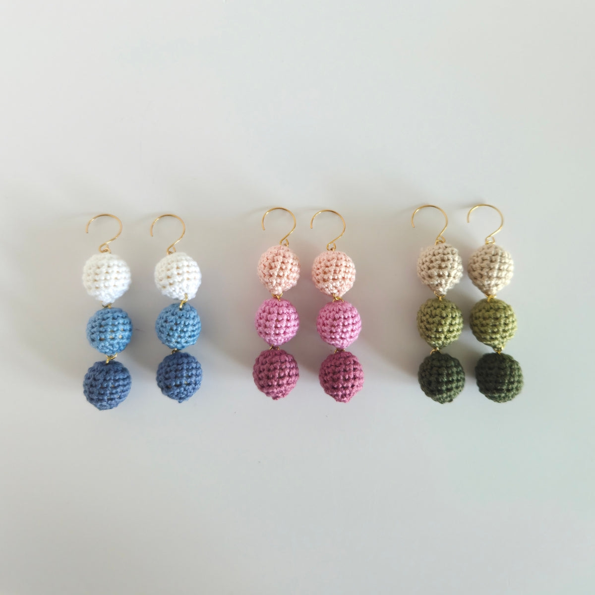 Set of colorful beaded earrings on a light gray background